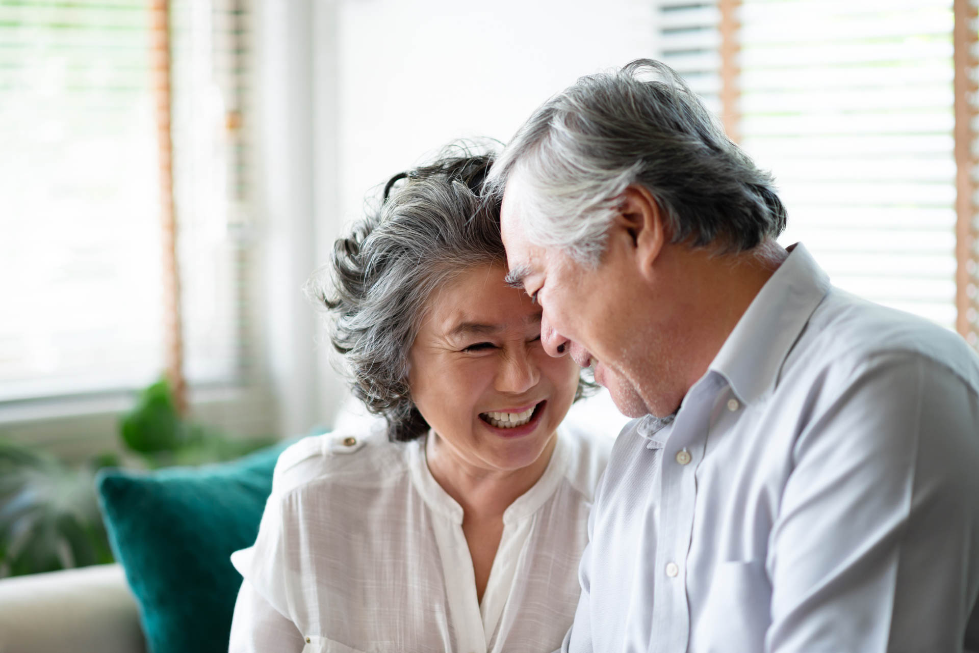 Asian senior couple in love laughing.